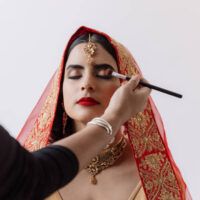 Shot of a beautiful young woman getting her makeup done on her wedding day